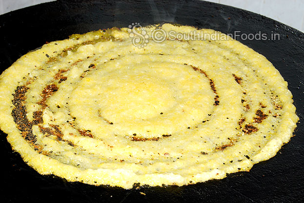 Heat iron dosa tawa, pour batter, spread it to round shape then pour 2 tbsp of oil around dosa, cover it & cook for both sides