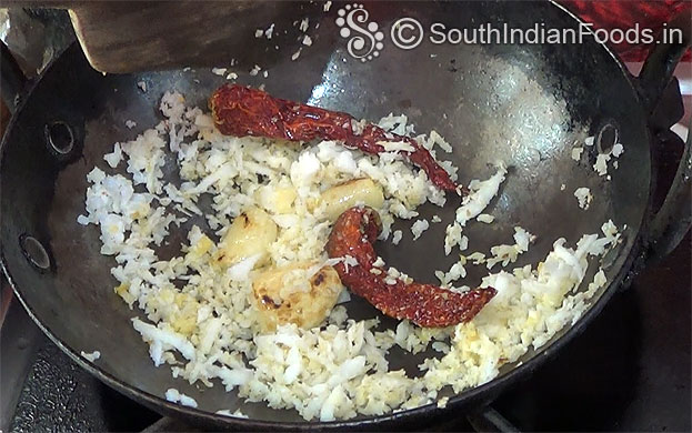Heat oil in a pan, add garlic, coconut,dry red chilli roast