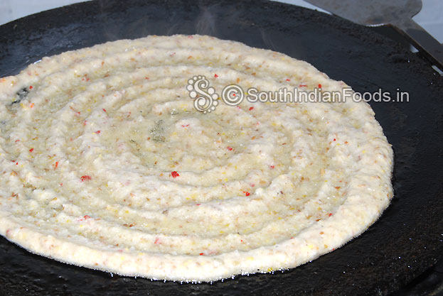 Heat iron dosa tawa, pour batter shape it, pour 1 tbsp oil around the adai and cook both sides till light brown