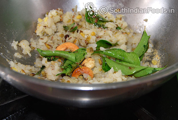 Add seasoned ingredients in to aval pongal
