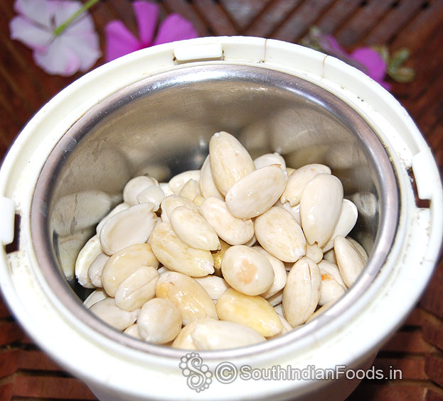Put almonds in a mixie jar, coarsely grind without water or milk