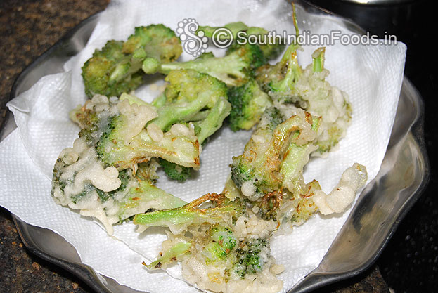Place broccoli into the cornflour& maida mixture then deep fry till crisp golden brown