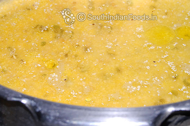Add dry roasted moong dal, cornmeal, water & ghee in a pressure cooker, cover, cook for 3 whistles.