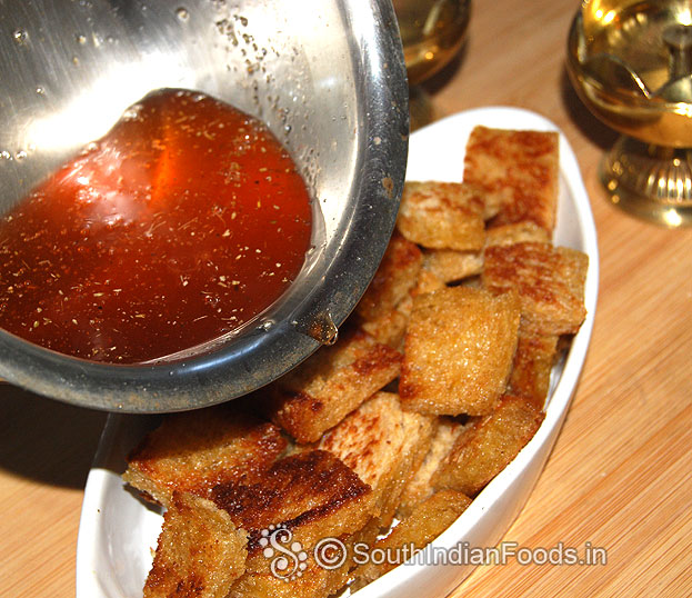Arrange ghee roasted bread cubes in a bowl, pour sugar syrup