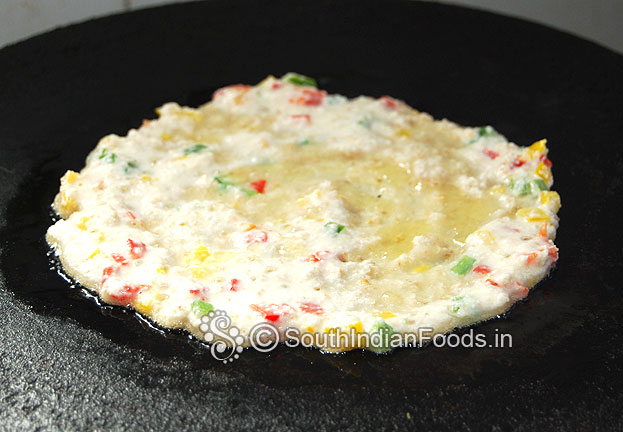 Pour 1 table spoon of oil around the oats dosa
