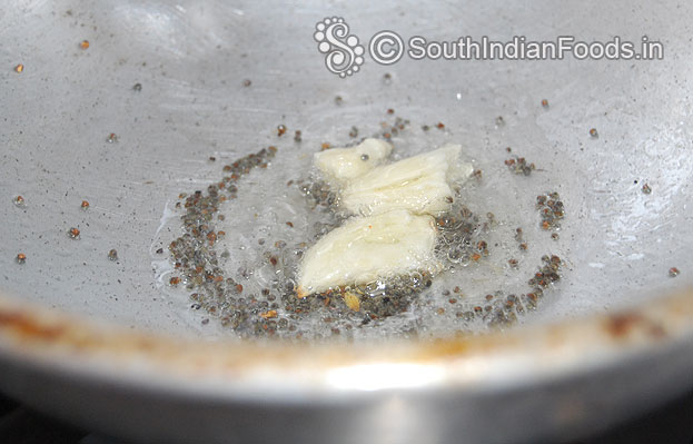 Add mustard let it crackle then add garlic