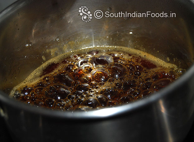 Cook jaggery syrup till soft balls forming consistency