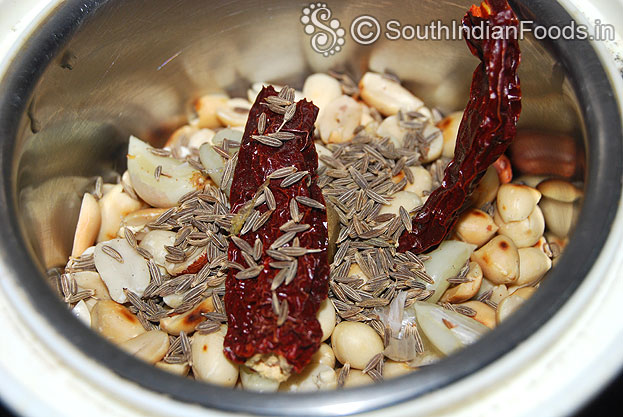 In a mixie jar, add roasted peanuts, cumin seeds, garlic, dry red chilli grind to fine paste