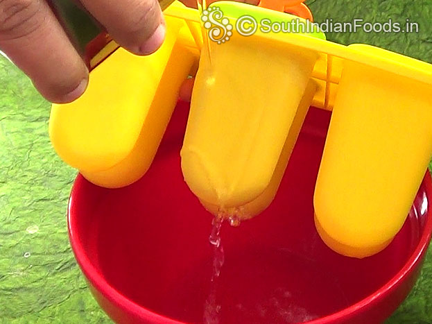 Take moulds from fridge & pour water over the moulds