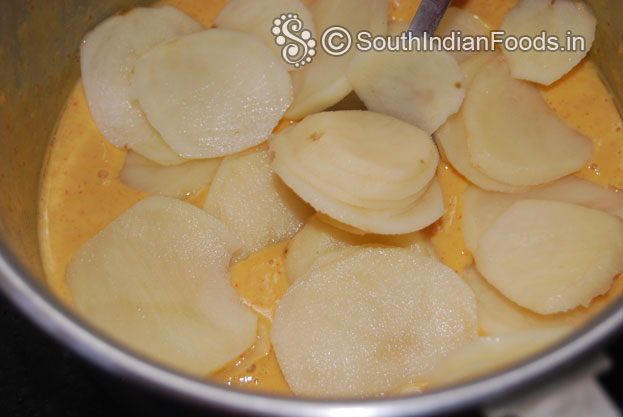 Add sliced potatoes in to gram flour batter