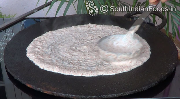 Heat iron dosa tawa, pour ragi batter, spread immediately