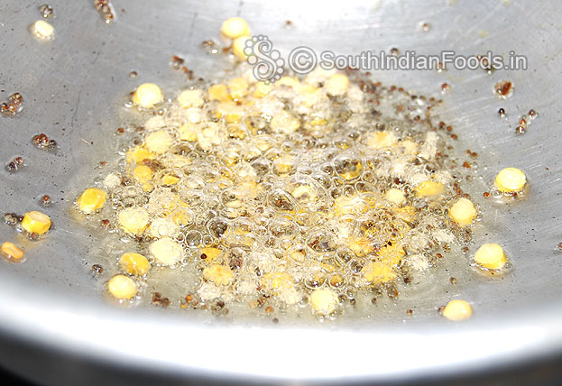 Heat oil in a pan, add mustard seeds, bengal gram & urad dal
