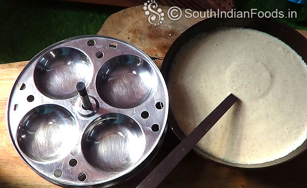 After fermentation, grease idli plates with sesame oil