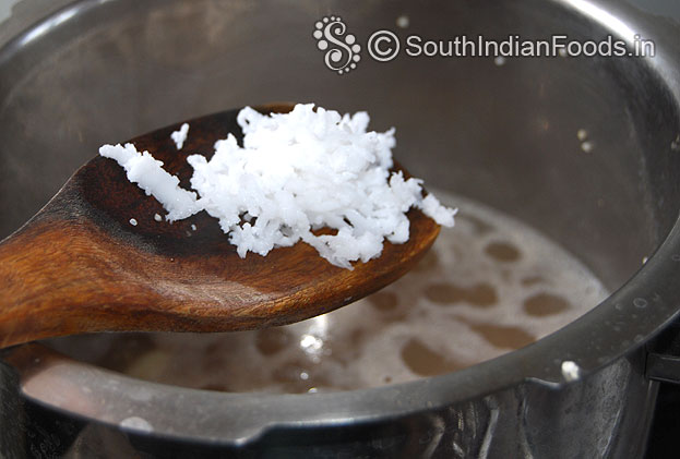 Add grated coconut in to the ulundu sadam