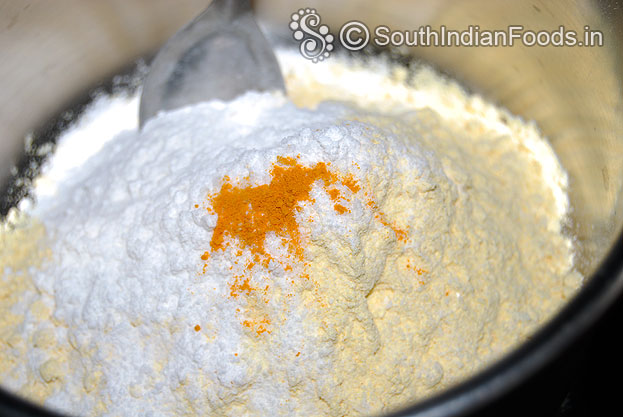 In a bowl add gram flour, rice flour, turmeric powder & salt