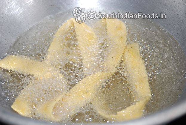 Heat oil in a pan, squeeze over the oil deep fry both sides till crisp & light brown.