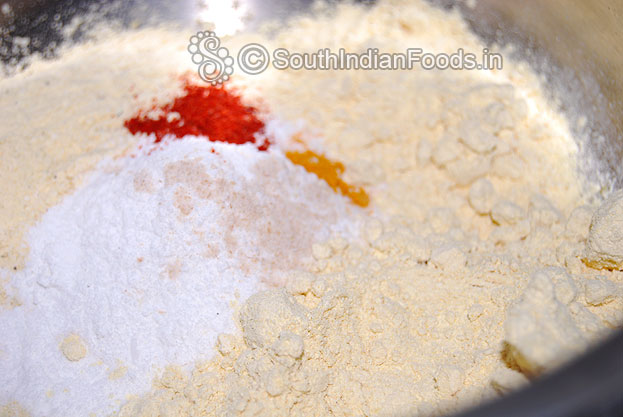 In a bowl add ground roasted gram gram, rice flour, asafetida, turmeric & red chilli powder
