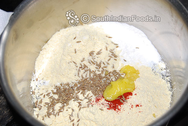Add cumin seeds, ghee, red chilli powder, asafetida and salt mix well then add water make soft dough.