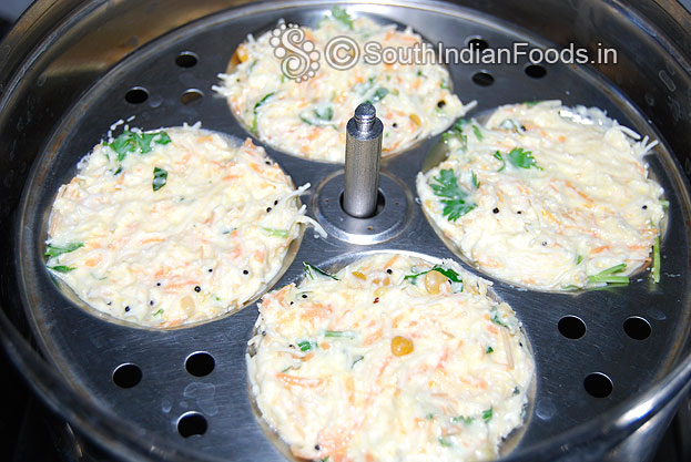 Pour batter in an idli plates & steam it for 10 min.