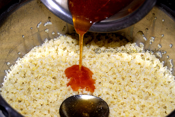 Adding jaggery syrup to cooked thinai rice