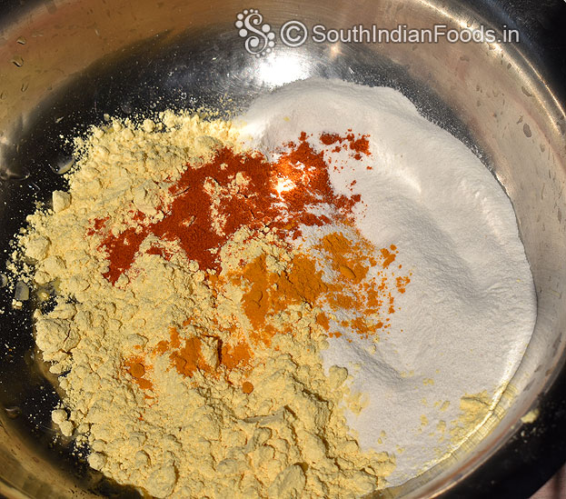In a bowl add besan, rice flour, red chilli powder & turmeric powder