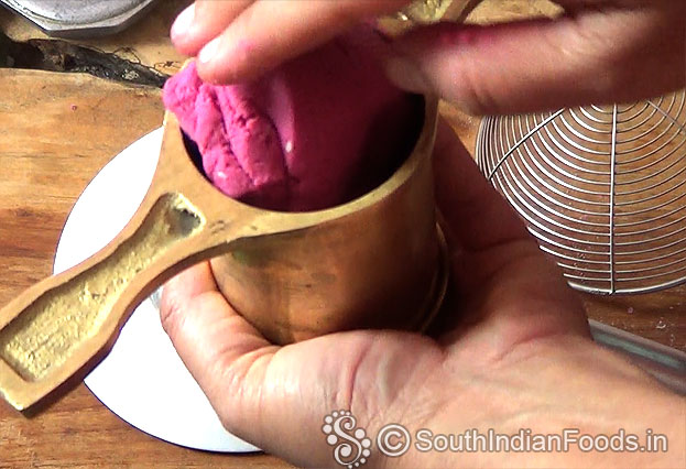 Put one handful dough into the murukku kuzhal