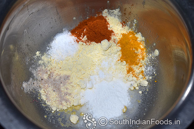 In a bowl add besan, rice flour, red chilli, turmeric powder, asafoetida, mix well