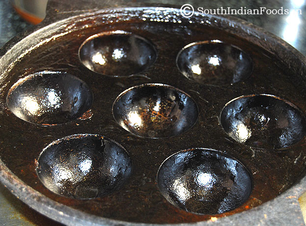 cast iron paniyaram pan with oil greased