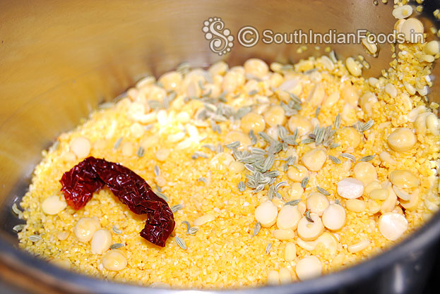 Soak corn meal, bengal gram, moong dal, drain water. In a mixer jar add soaked ingredients, fennel seeds, dry red chilli, salt coarsely grind with out water.
