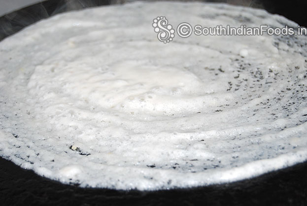 Pour 2 tbsp of oil around the dosa, cook till crisp and golden brown.