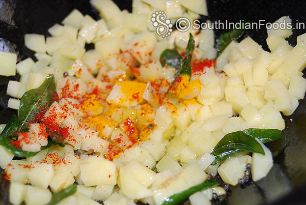 Heat oil in a pan add mustard seeds, curry leaves, garlic saute then add potato, red & turmeric powder, salt saute