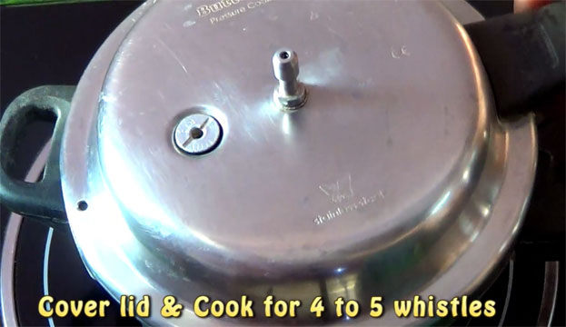 Cover lid, cook for 4 to 5 whistles