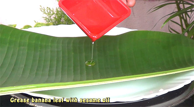 Grease banana leaf with sesame oil