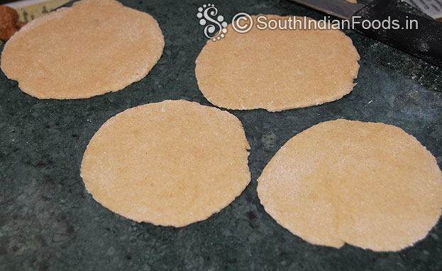 Sprinkle flour, roll out into small puri