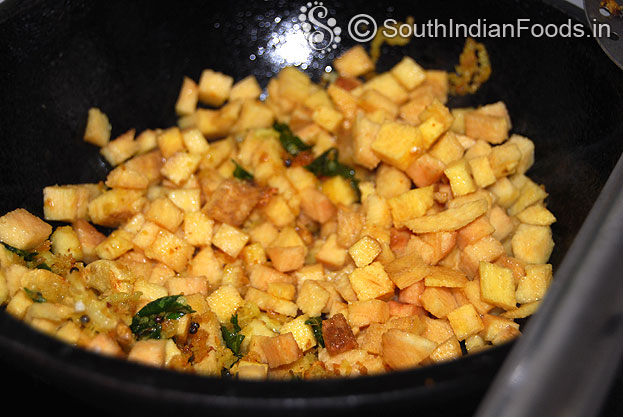 Heat oil, add mustard, chan dal, urad dal, garlic, curry leaves, hing, coconut & yam saute