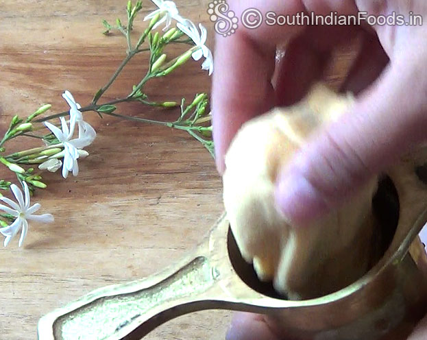 Add one handful dough into the murukku kuzhal