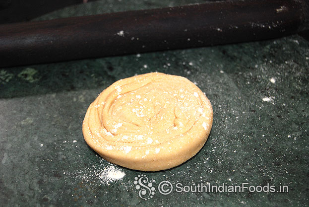 Sprinkle flour, rollout into thick paratha