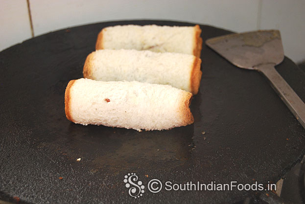 Heat iron dosa tawa, place bread roll