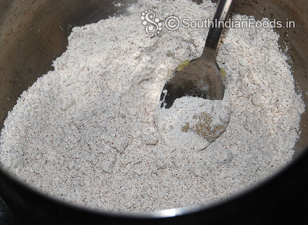 In a bowl add ragi flour, wheat flour, cardamom powder & ghee mix well