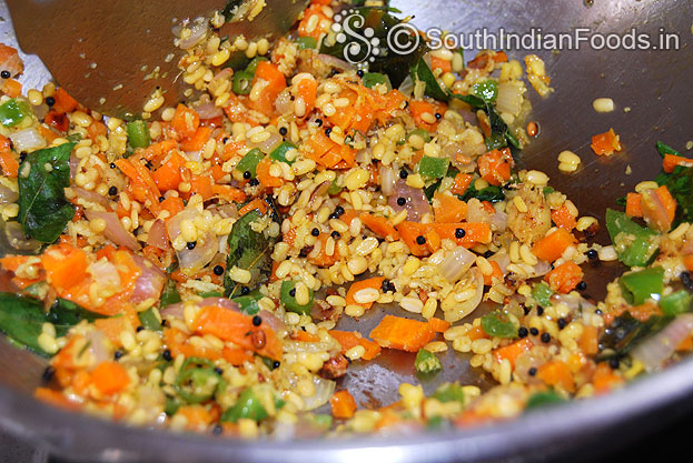 Heat oil in a pan add seasoned ingredients, vegs, moong dal, red chilli & turmeric powder saute