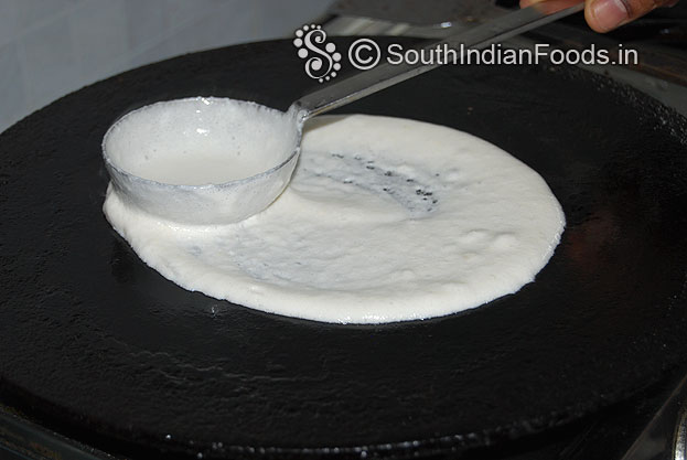 Heat iron dosa tawa, sprinkle water pour 1 laddle full batter and evenly spread