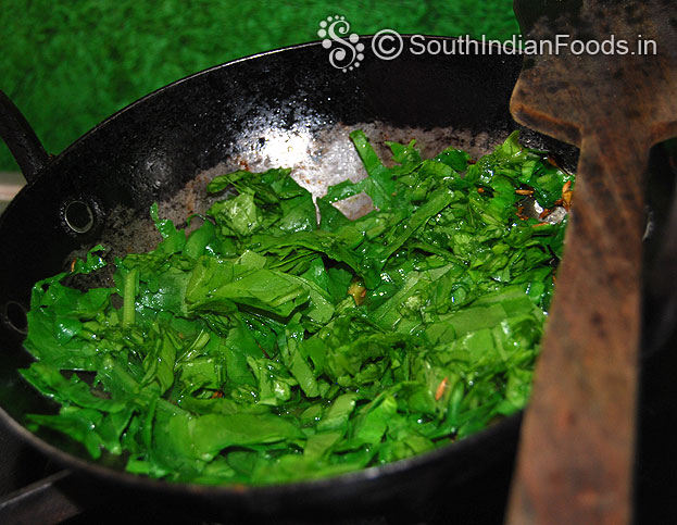 Heat ghee add seasoned ingredients, then spinach saute till soft