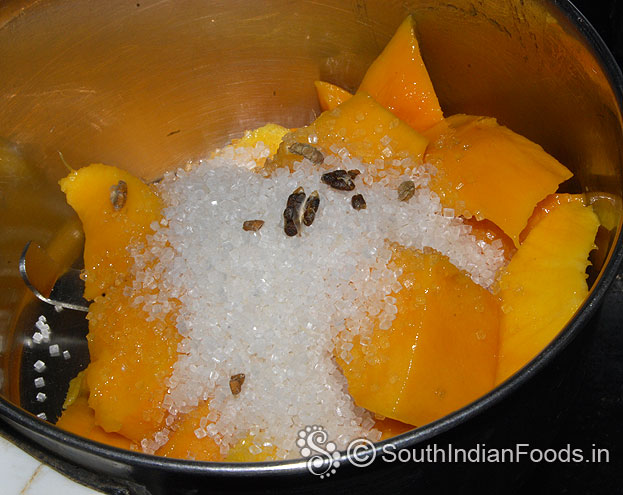 In a mixie jar add mango cubes, cardamom & sugar grind well