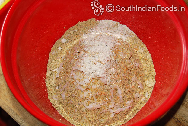 In a bowl add ground green gram powder, roasted coconut