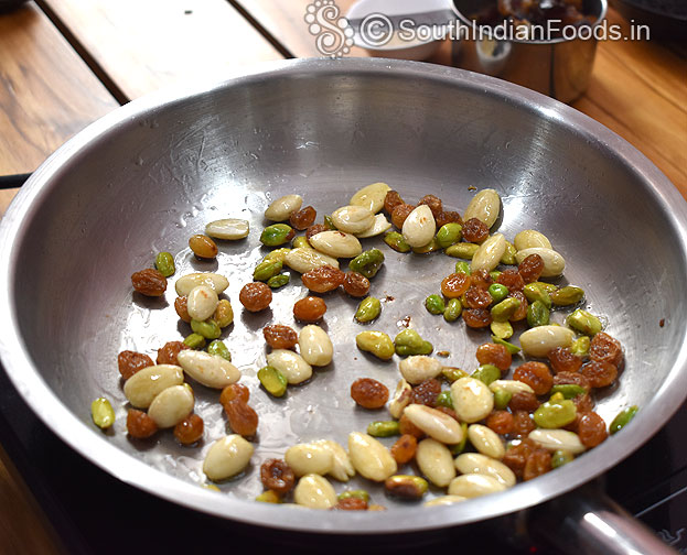 Add 1 tbsp ghee, add blanched almond, pista and raisins, saute