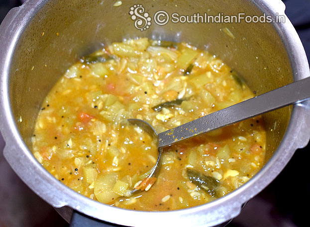 Heat pressure cooker add toor dal, tomato, onion, garlic, turmeric, green chilli, gingelly oil 