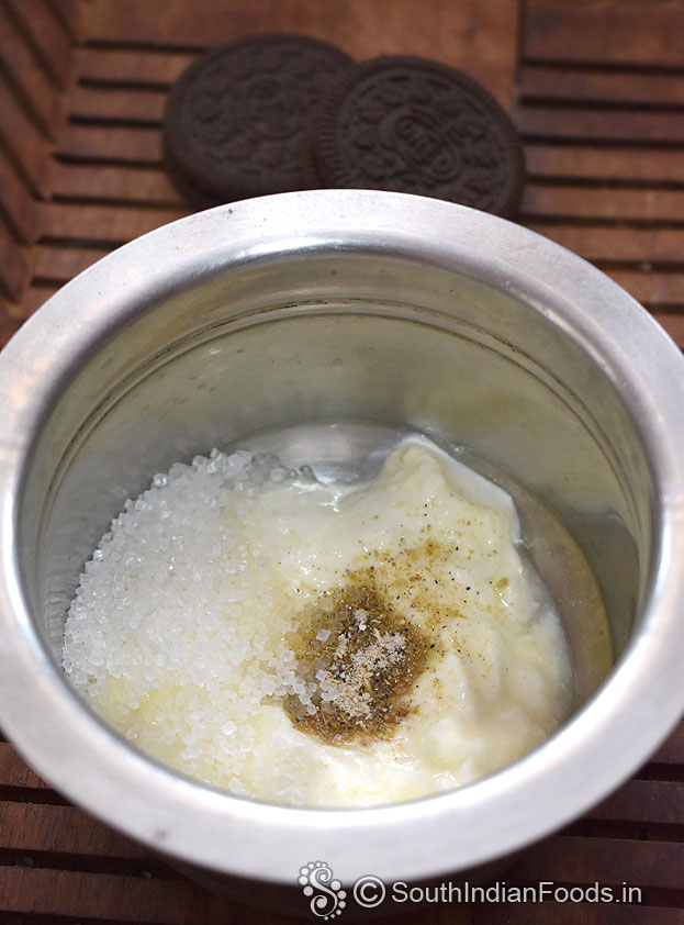 In a bowl add fresh curd, cardamom powder & sugar