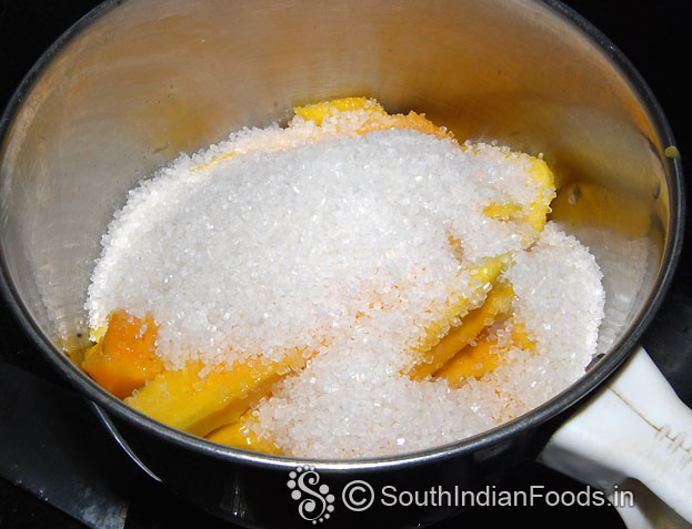 In a mixer jar add mango and sugar, finely grind
