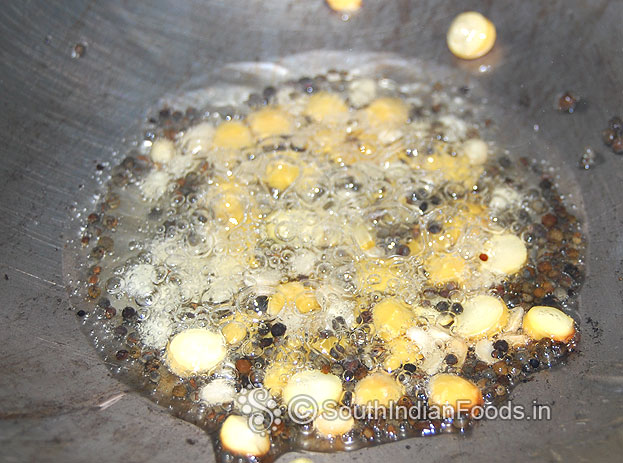 Heat oil in a pan add mustard & let its splutter. Then add bengal gram, urad dal saute