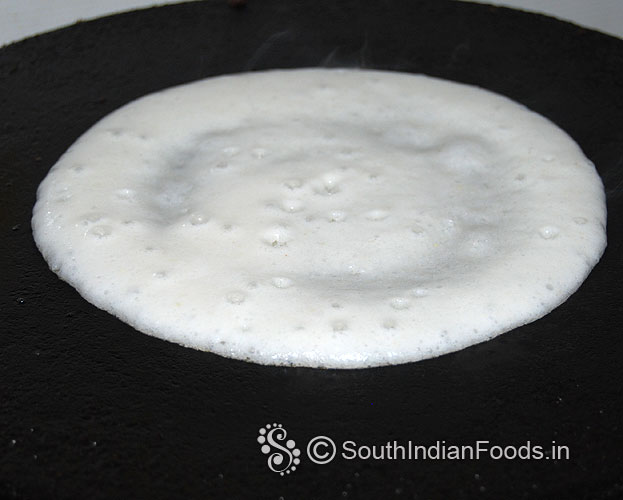 Heat dosa tawa, pour batter, gently spread 